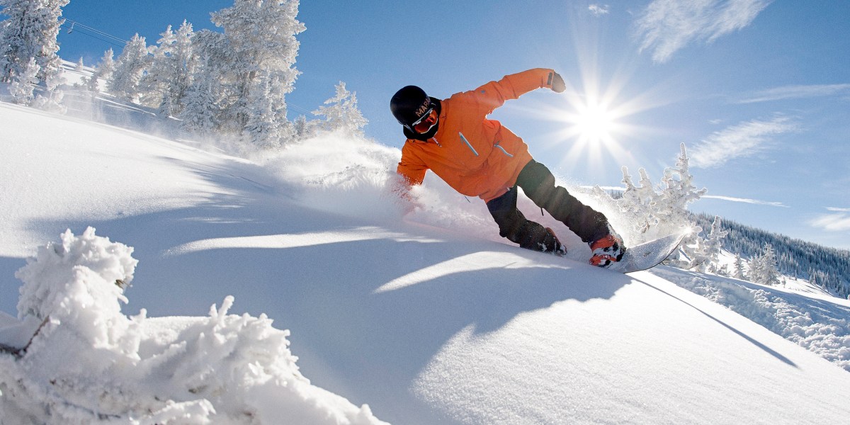 A snowboarder turns in fresh powder in Vail, Colorado.