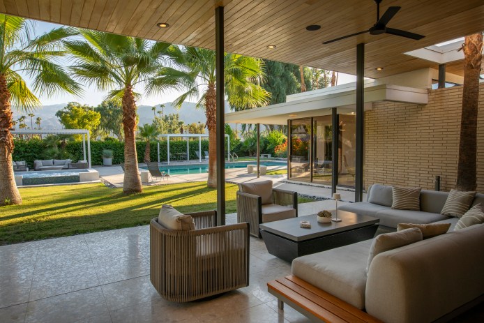 Patio with a seating area overlooking a mid-century pool