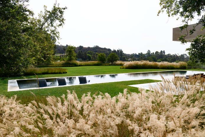 Exterior featuring a pool and lush greenery
