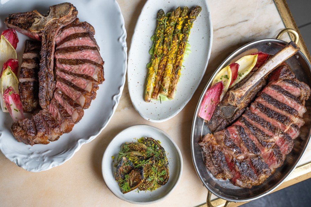 Plates with food, including steak and asparagus