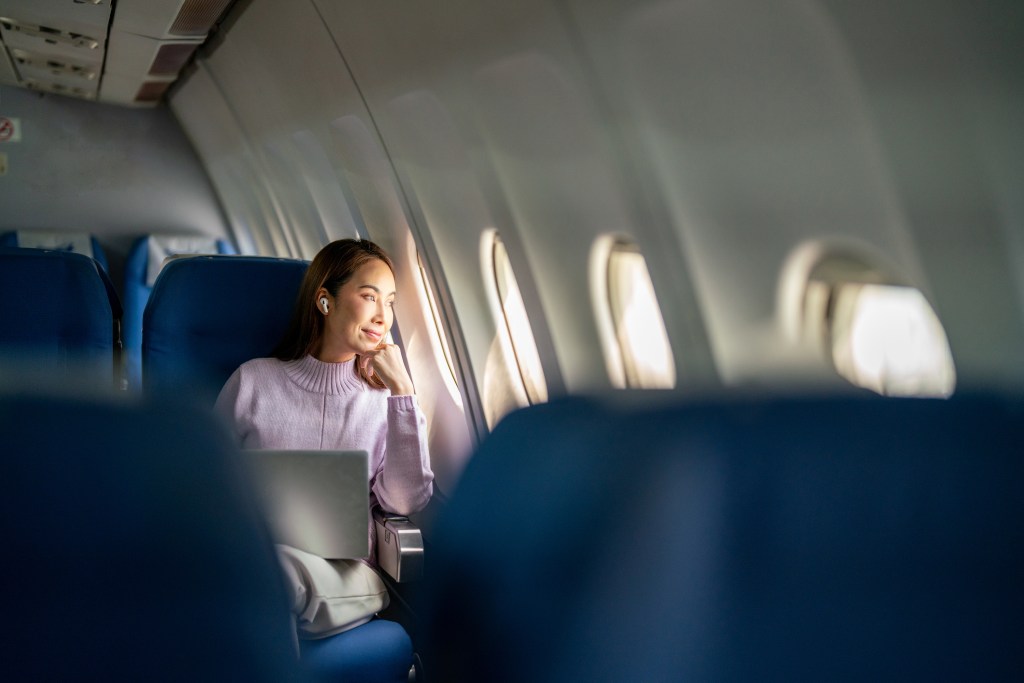 Woman in window seat on a plane