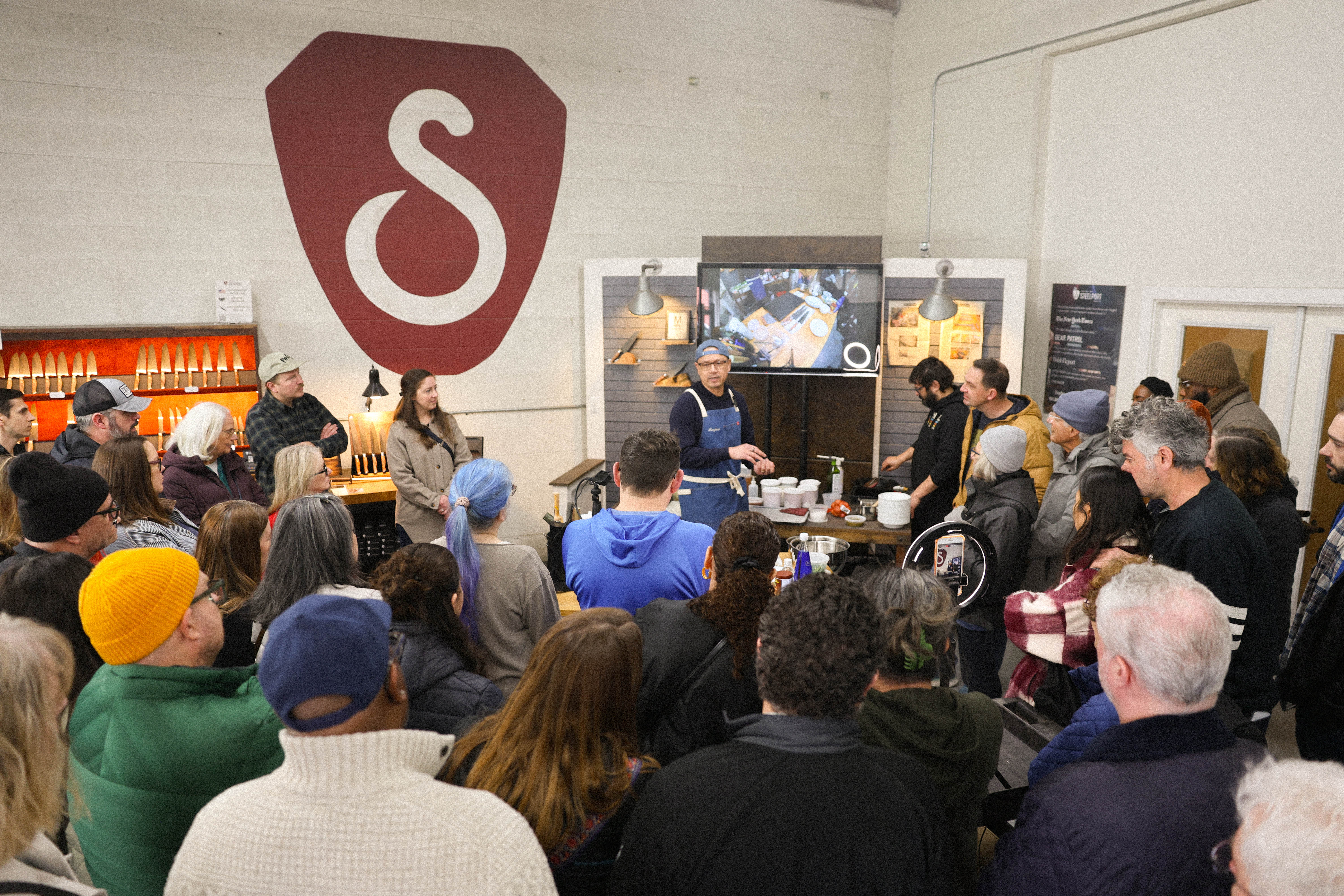 a-crowd-learns-from-chef-earl-ninsom-of-laangban-at-a-recent-monthly-knife-skills-demo-at-the-steelport-factory