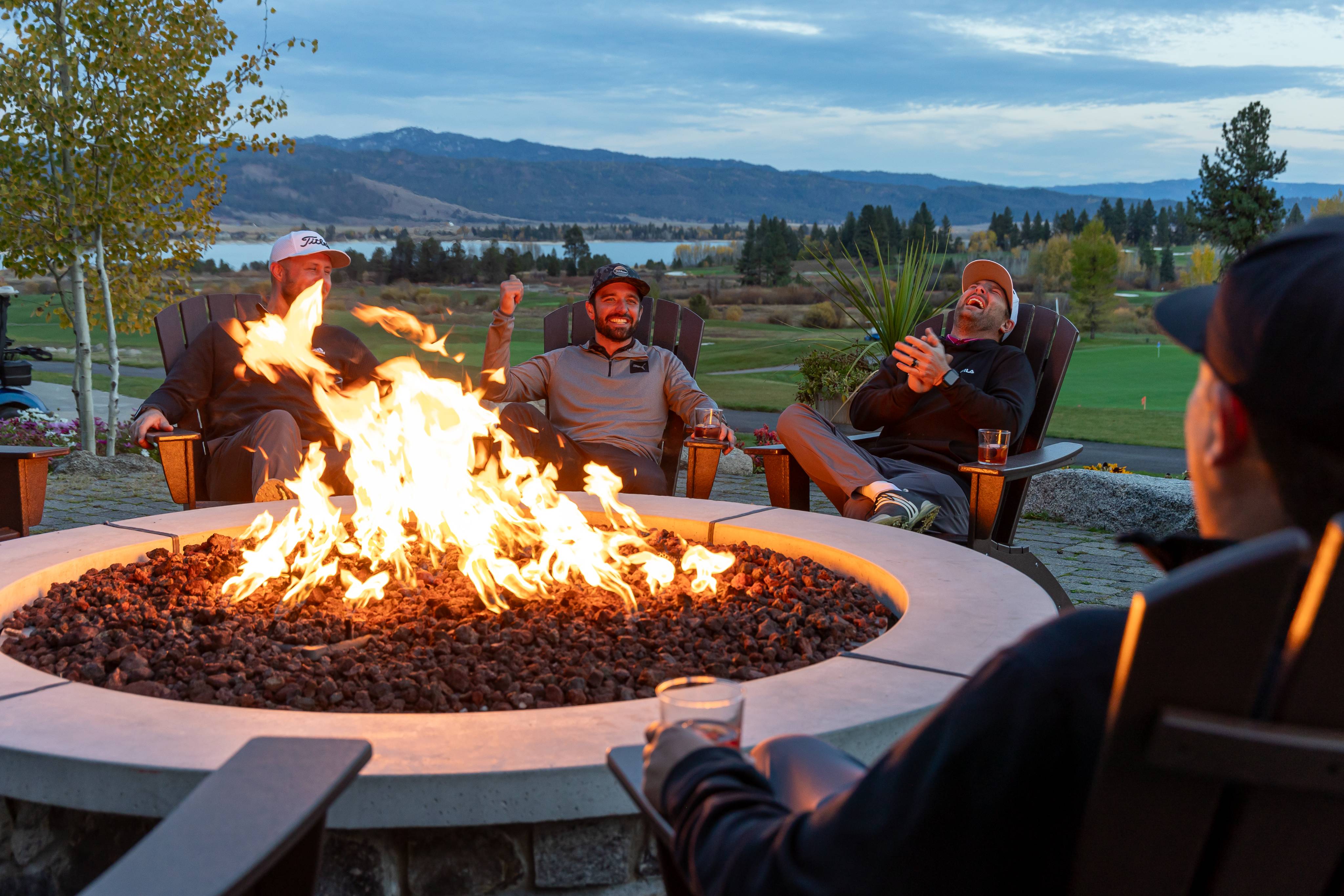 friends-enjoy-drinks-by-the-fire-after-a-full-day-of-golfing-at-the-osprey-meadows-golf-course
