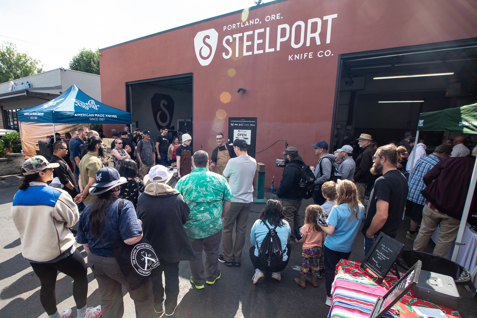 crowd-enjoys-a-knife-forging-demonstration-outside-steelport-during-knife-day-showcase-event