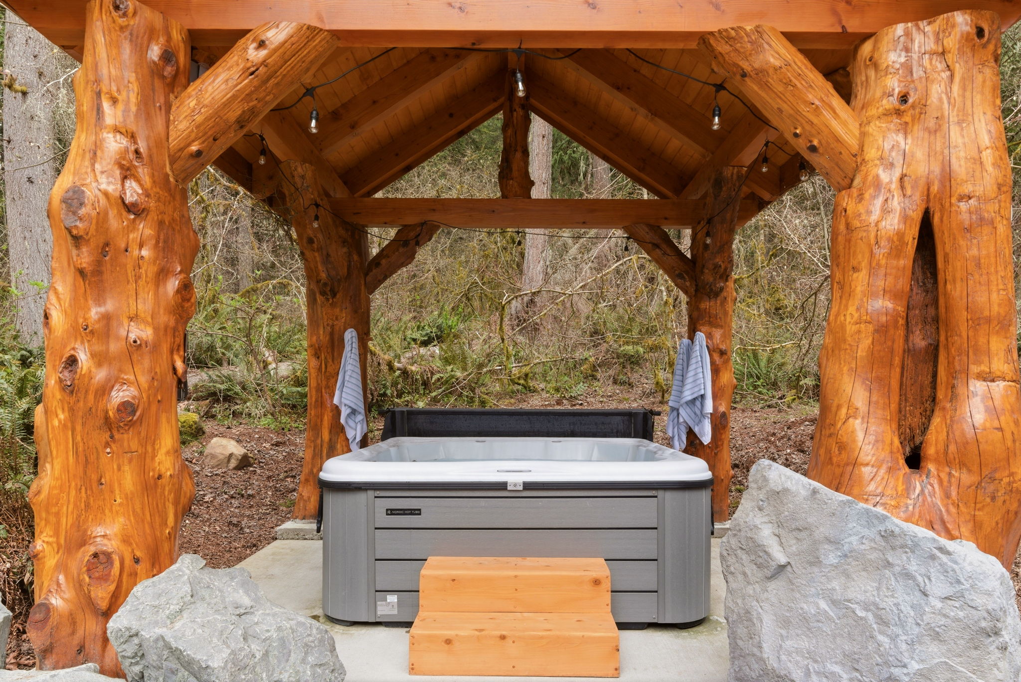 the-cedar-log-supported-hot-tub-pavilion-hand-crafted-by-design-set-into-the-edge-of-the-pacific-northwest-forest