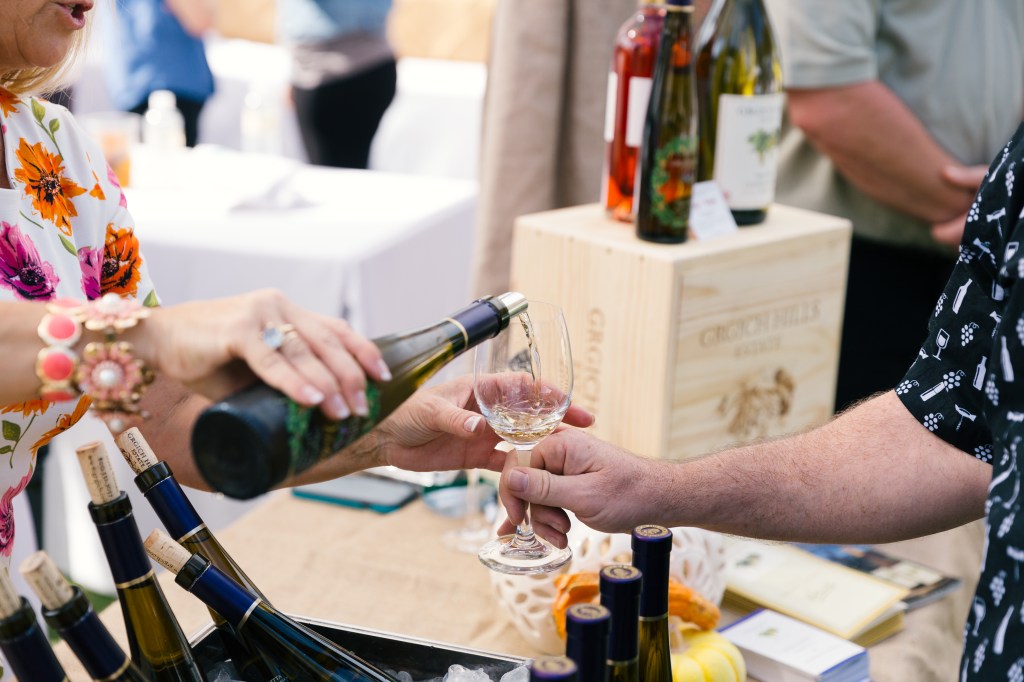 Person pouring wine.