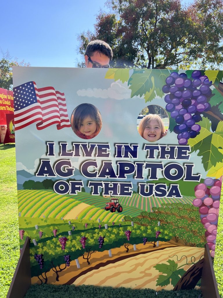 Kids posing with sign.