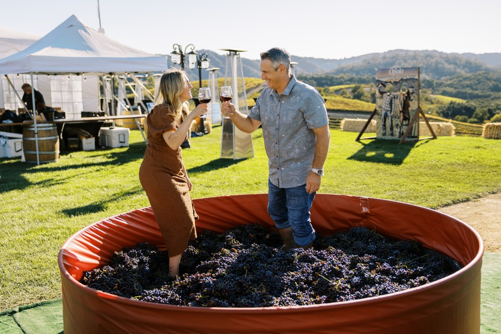 People stomping on grape vats.