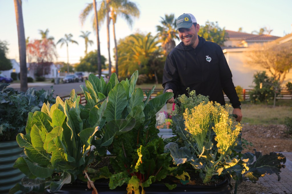 Kevin Espiritu Watering a Raised Bed