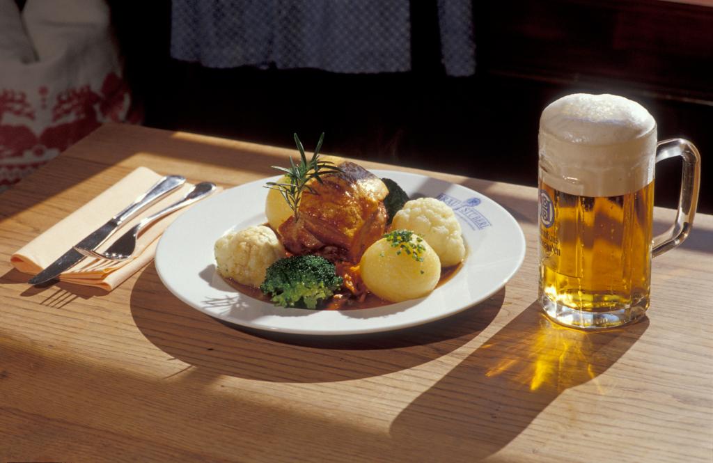 Oktoberfest beer with pork knuckle and potato dumplings.