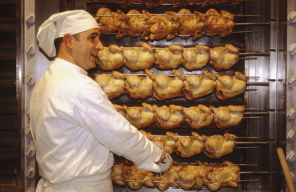 Oktoberfest chef roasting chickens.