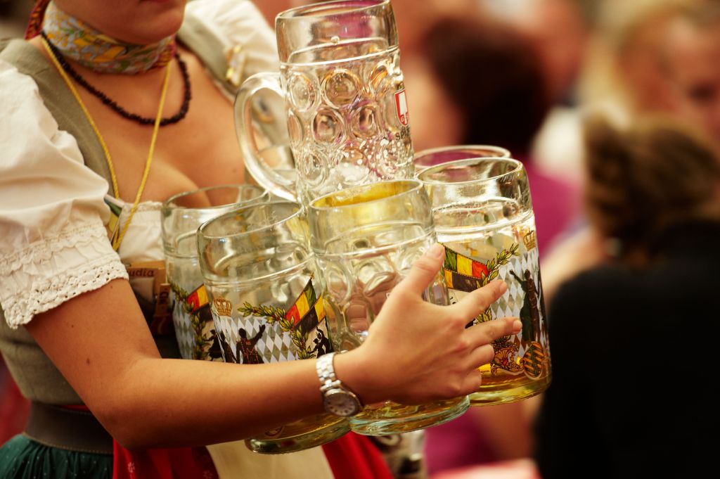 Oktoberfest women carrying beer glasses.