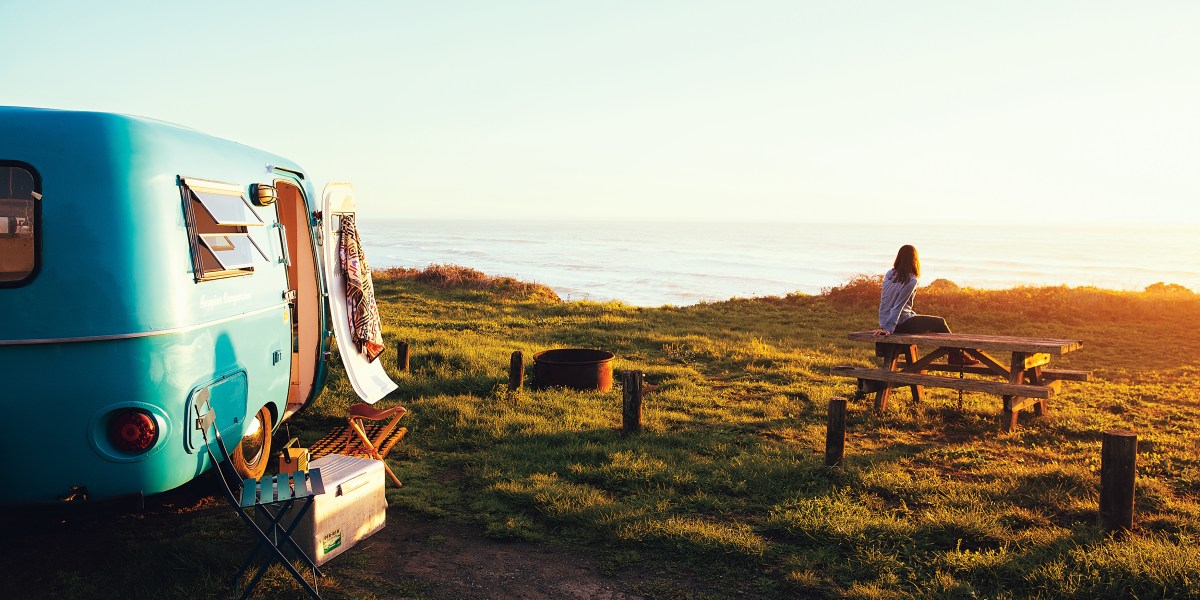 Airstream/RV at camp with picnic table and coastal view