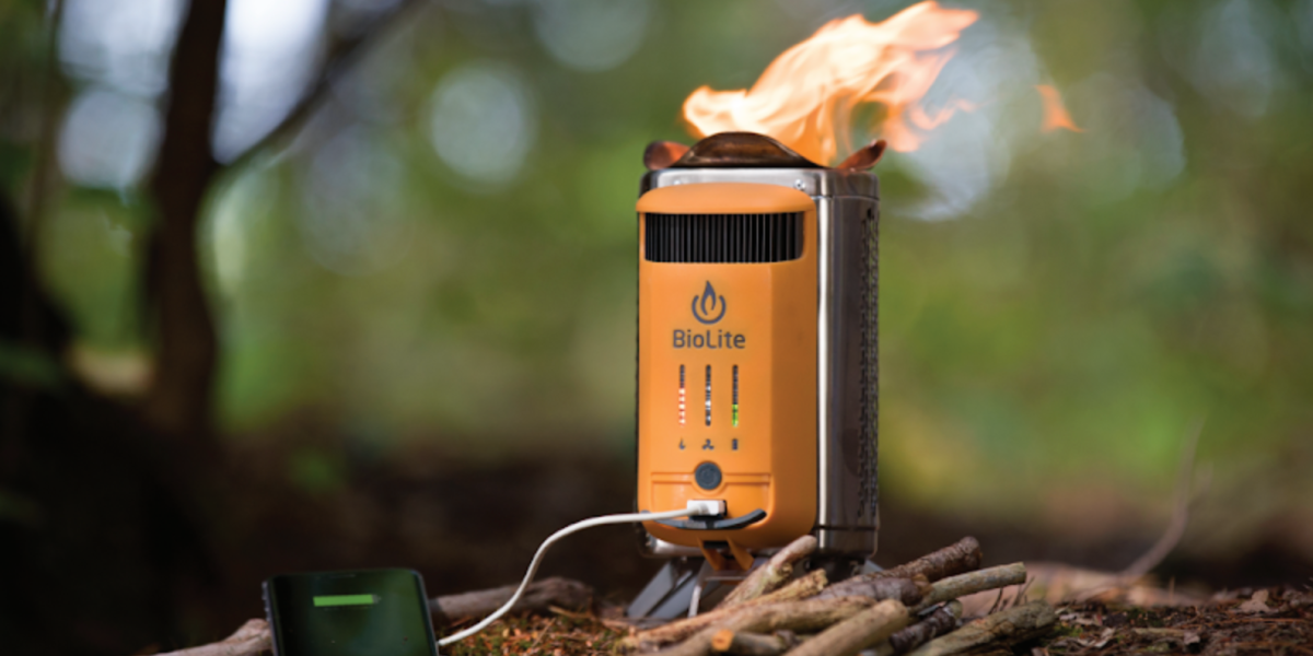 stove on ground produces low flame, attached battery pack charges phone