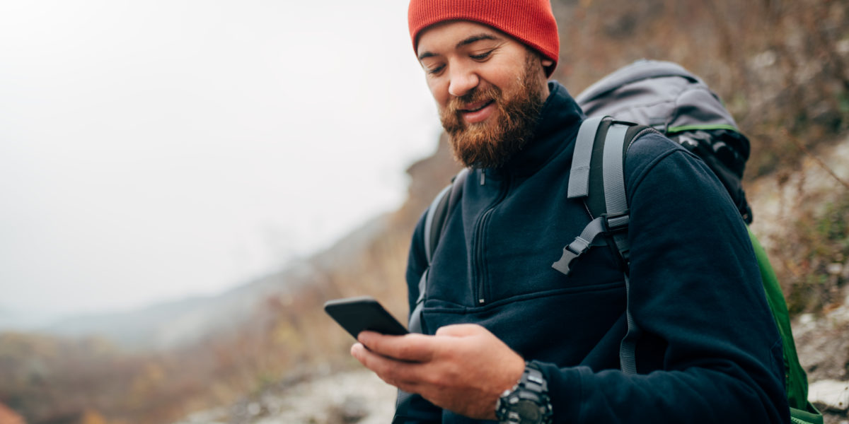 Guy with Phone on Trail