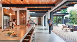 Newport Beach home kitchen with stools, beams, indoor/outdoor space