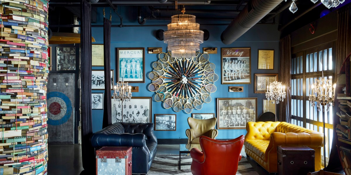 The eclectic interiors of an athletic club, featuring framed photos and an art installation made from old fashioned tennis rackets.