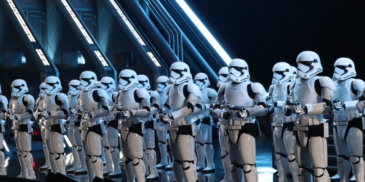 Storm Troopers greet the captured members of the Resistances in a massive Star Destroyer hanger.
