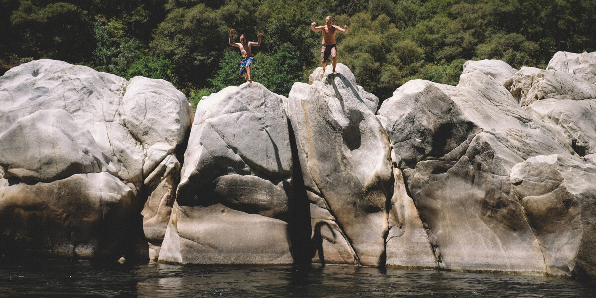 Two Boys Jump from Boulders at the Yuba River