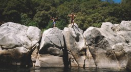 Two Boys Jump from Boulders at the Yuba River