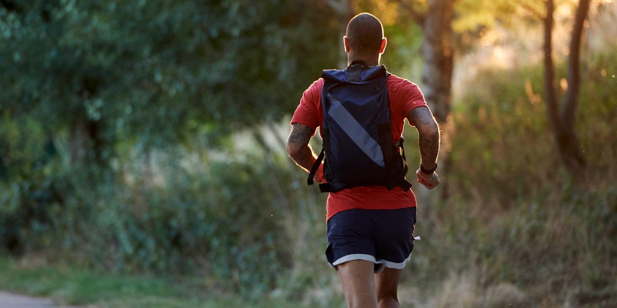 Tracksmith Backpack Running in Countryside with sunlight
