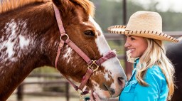 Devon Combs in a Cowboy Hat with a Horse