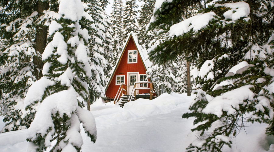 Red cozy cabin in the snow at Alpine Lakes High Camp
