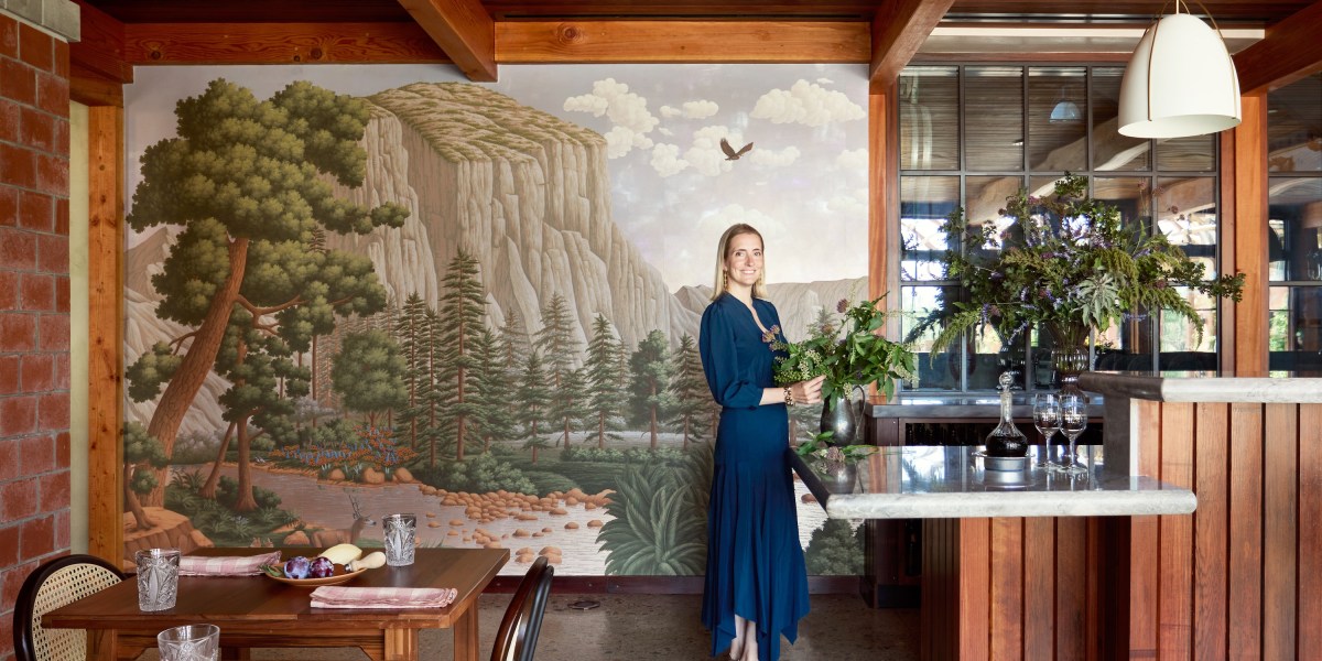 The interior of a winery, featuring a mural of a forest landscape