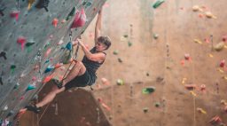 Climber scales a rock wall.