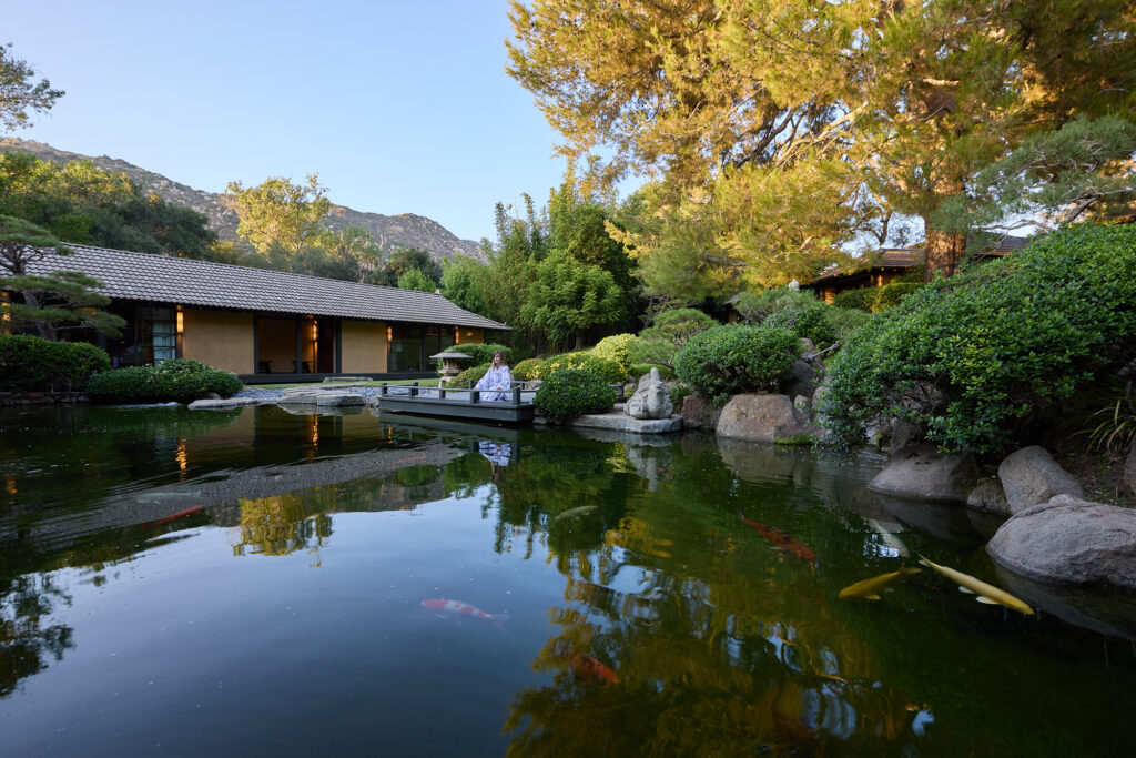 An outdoor meditation area overlooking a koi pond.
