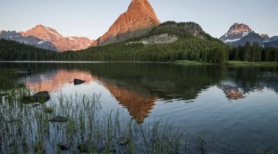 Sunrise view of Swiftcurrent Lake in Glacier National Park on a Highway 89