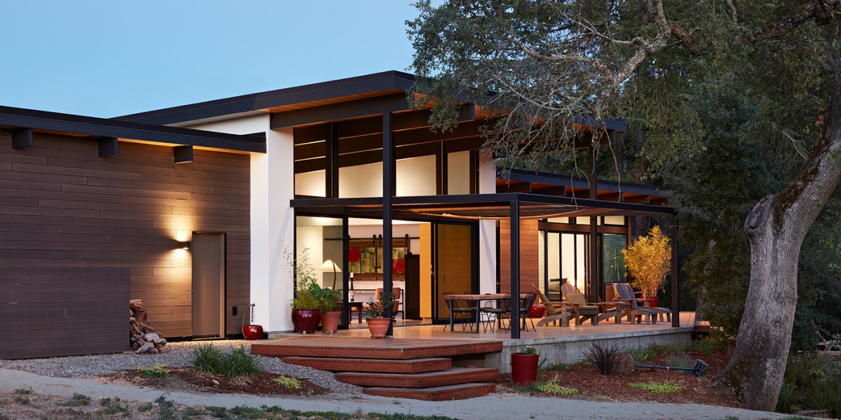Klopf Architecture in Sacramento designed this single-story modern house with intense summer heat in mind, building a patio under the shade of a mature oak with a large overhang.