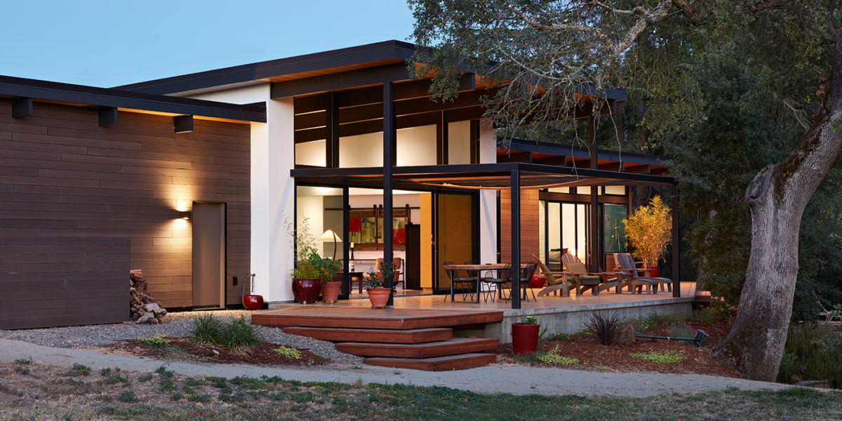 Klopf Architecture in Sacramento designed this single-story modern house with intense summer heat in mind, building a patio under the shade of a mature oak with a large overhang.