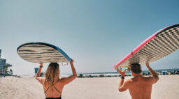 Simmons and O'Brien Carrying Surfboards