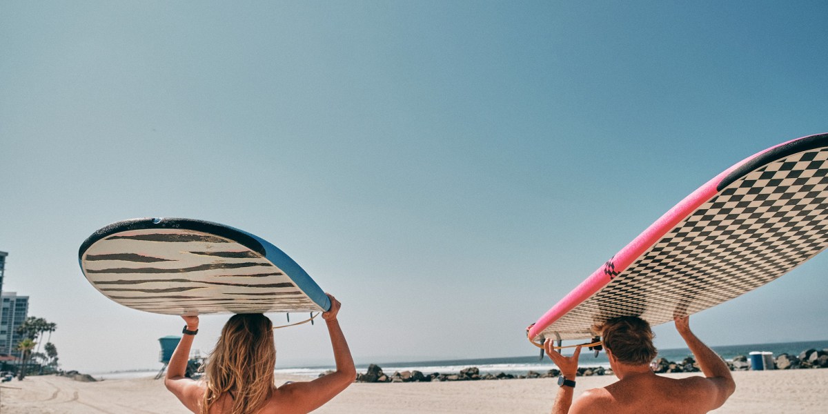 Simmons and O'Brien Carrying Surfboards