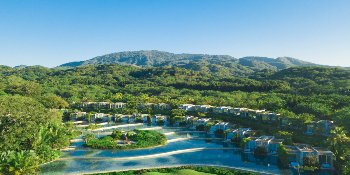 pools sit in the middle of lush greenery and green mountains