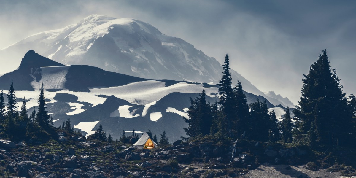 A campsite on a rocky flat area at Mount Rainier with grey skies overhead
