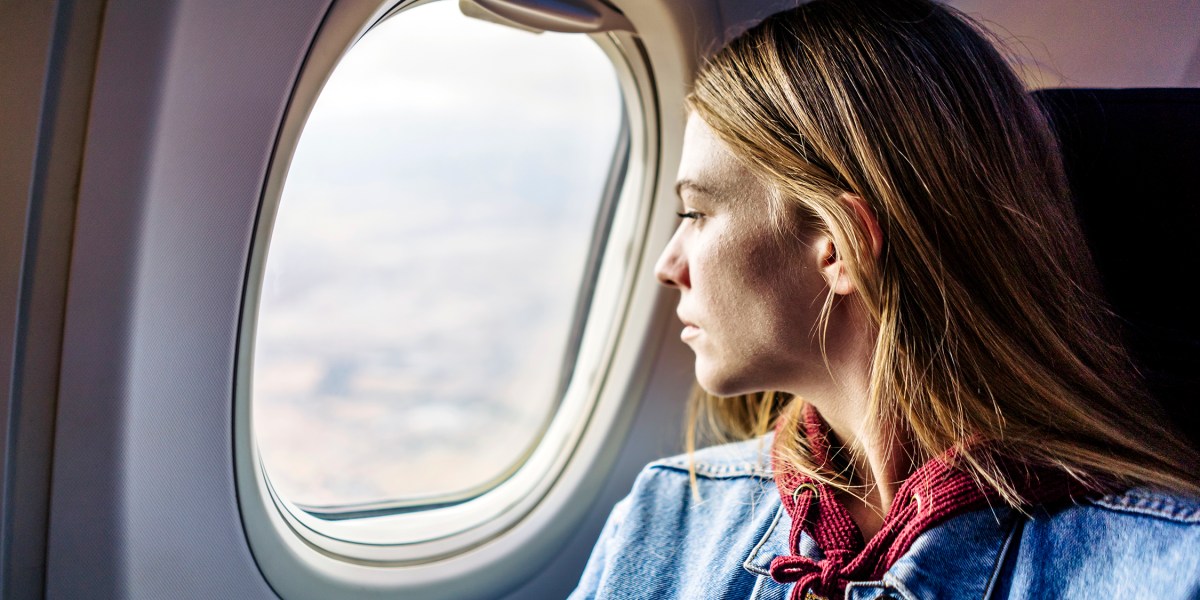 Woman Looking Out Airplane Plane Window