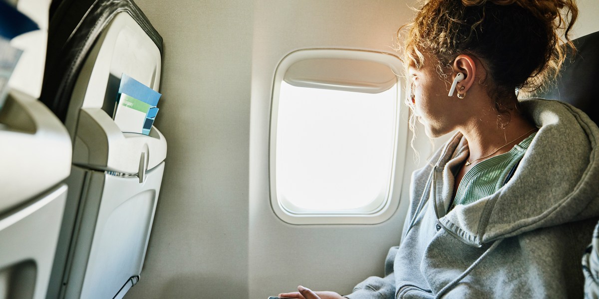 Woman Looking Out Airplane Window