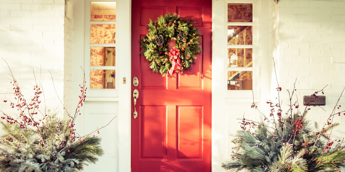 Exterior Red Door Decorated with a Wreath for Christmas